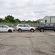 Três carros lado a lado mostrando diferentes tipos de carroceria: hatch branco, SUV prata e picape cinza-escura.